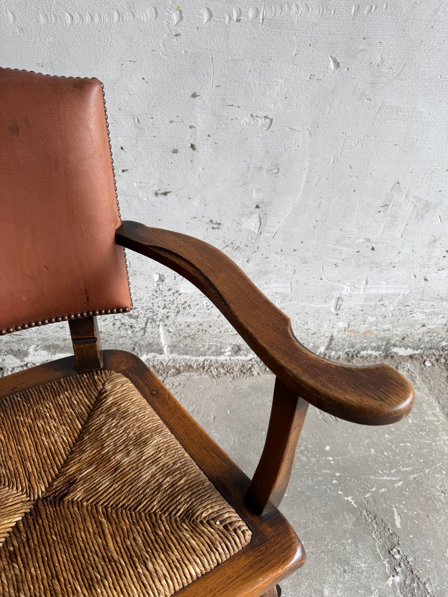 Brutalist armchair with rattan seat and leather back
