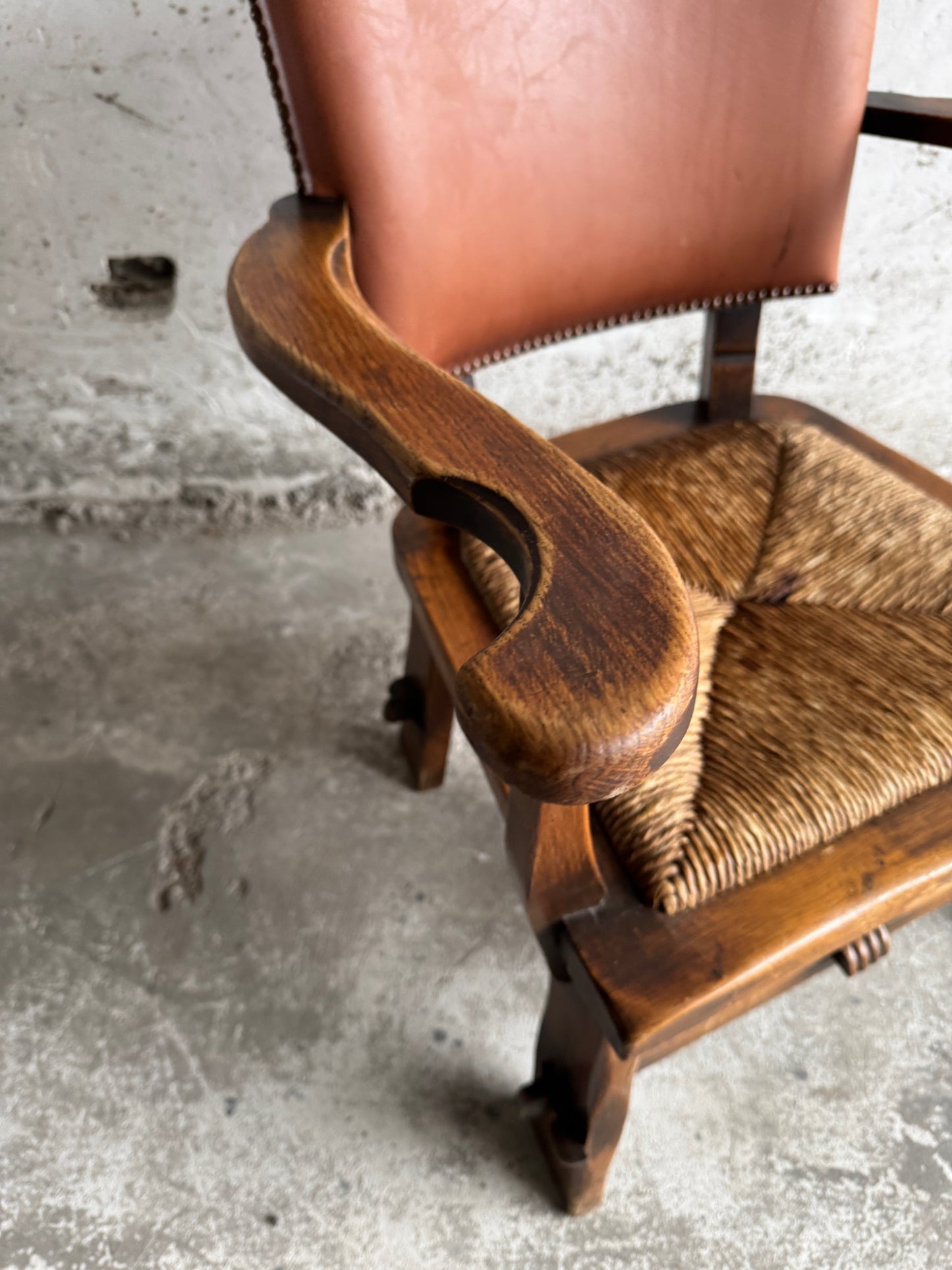 Brutalist armchair with rattan seat and leather back