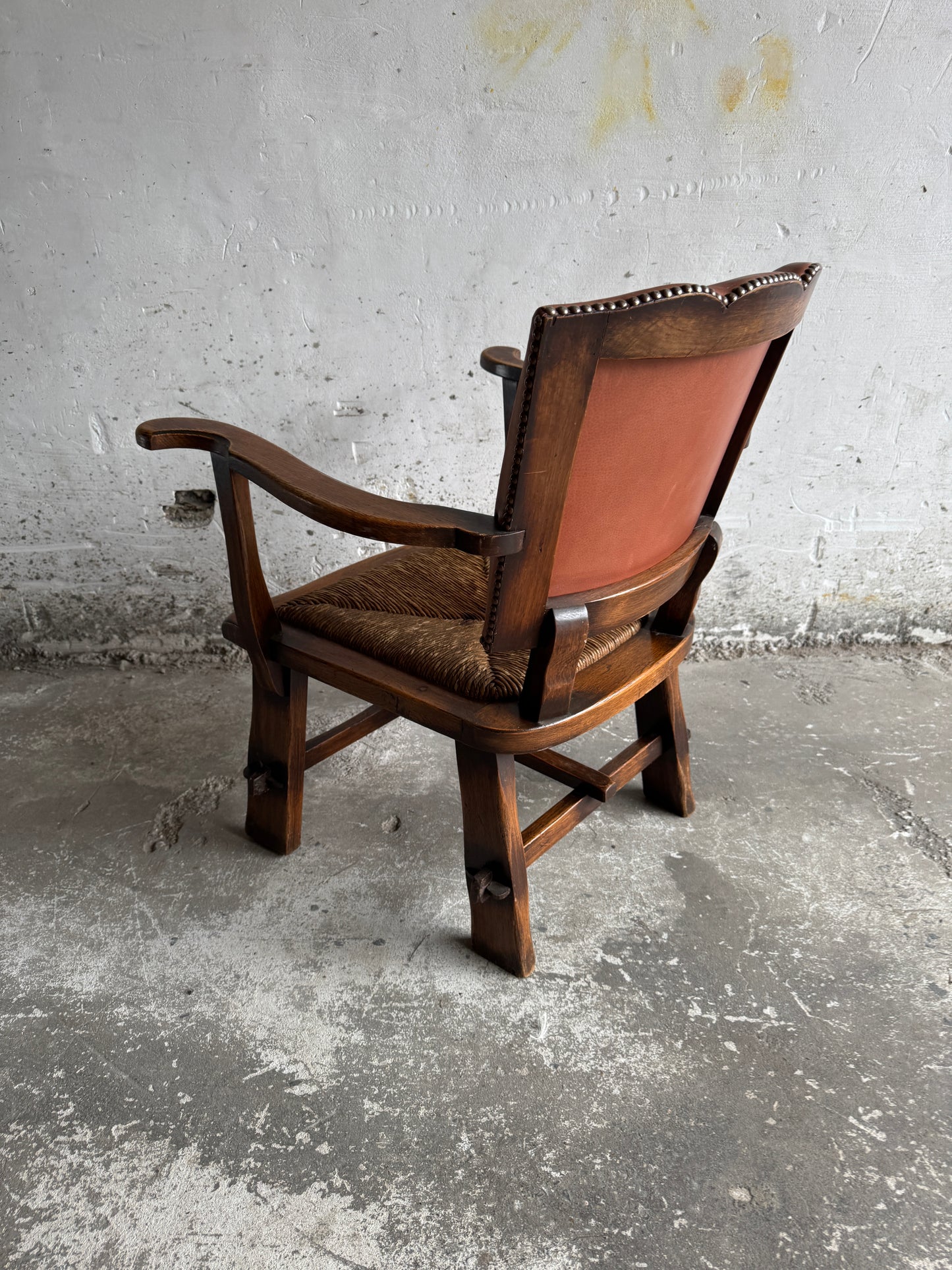 Brutalist armchair with rattan seat and leather back