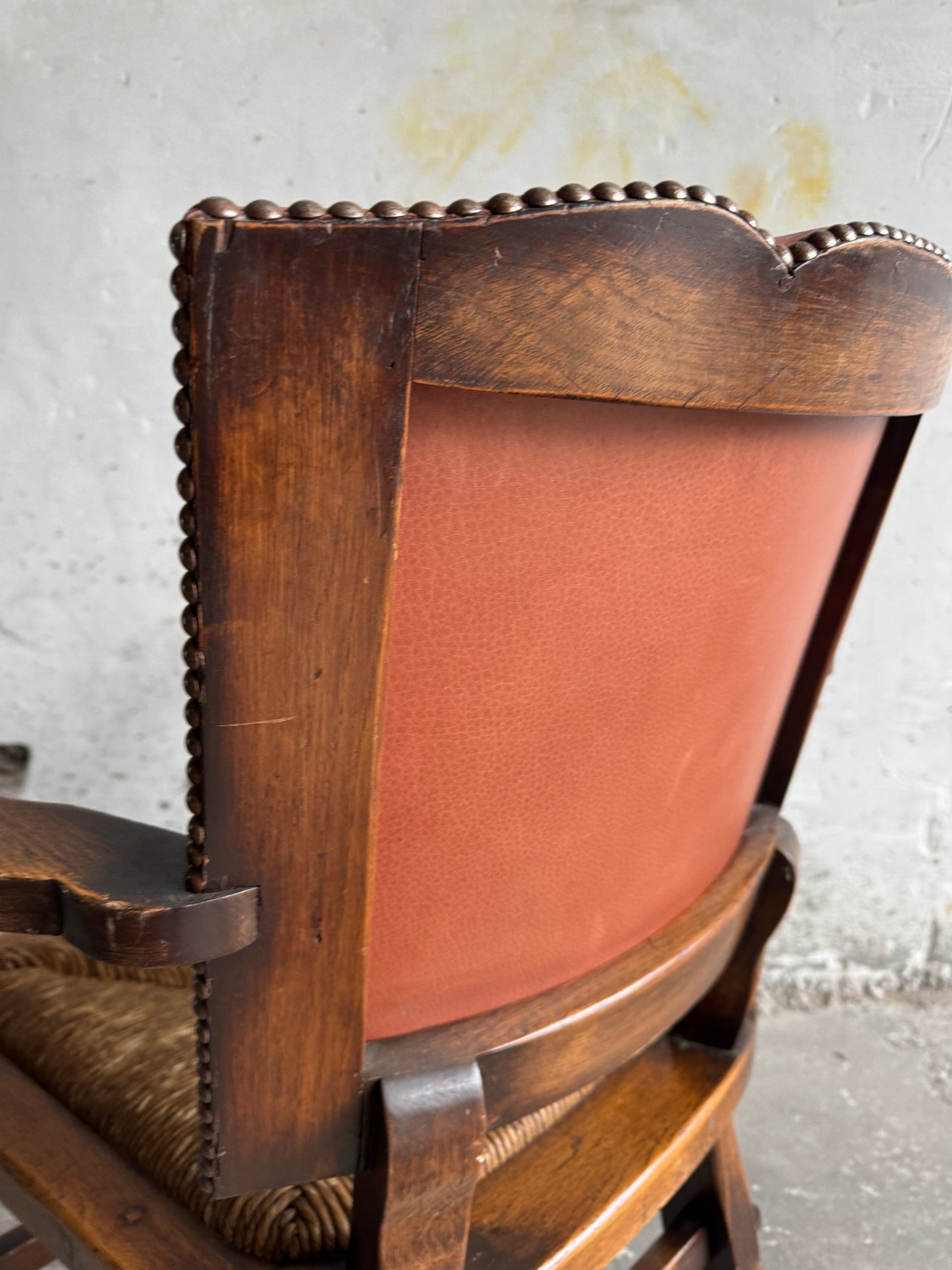 Brutalist armchair with rattan seat and leather back
