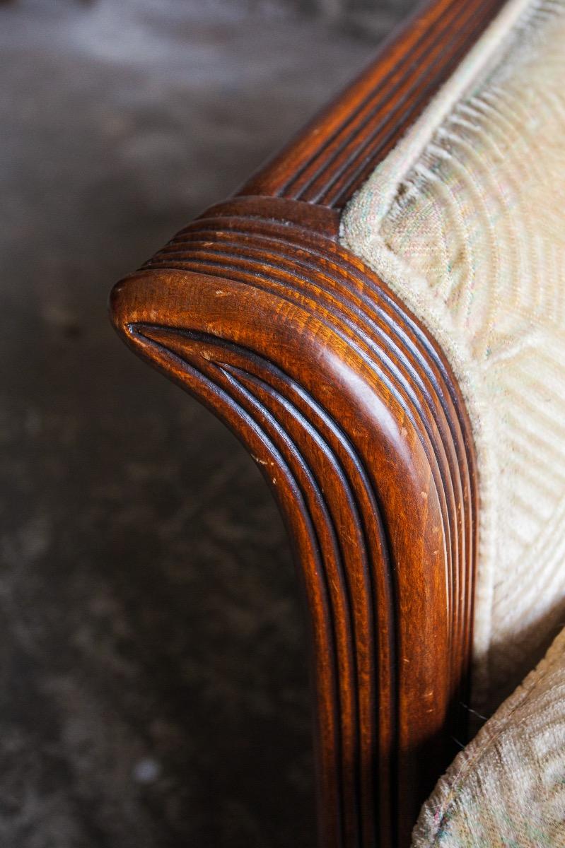Art Deco two-seater sofa with ornate wooden details