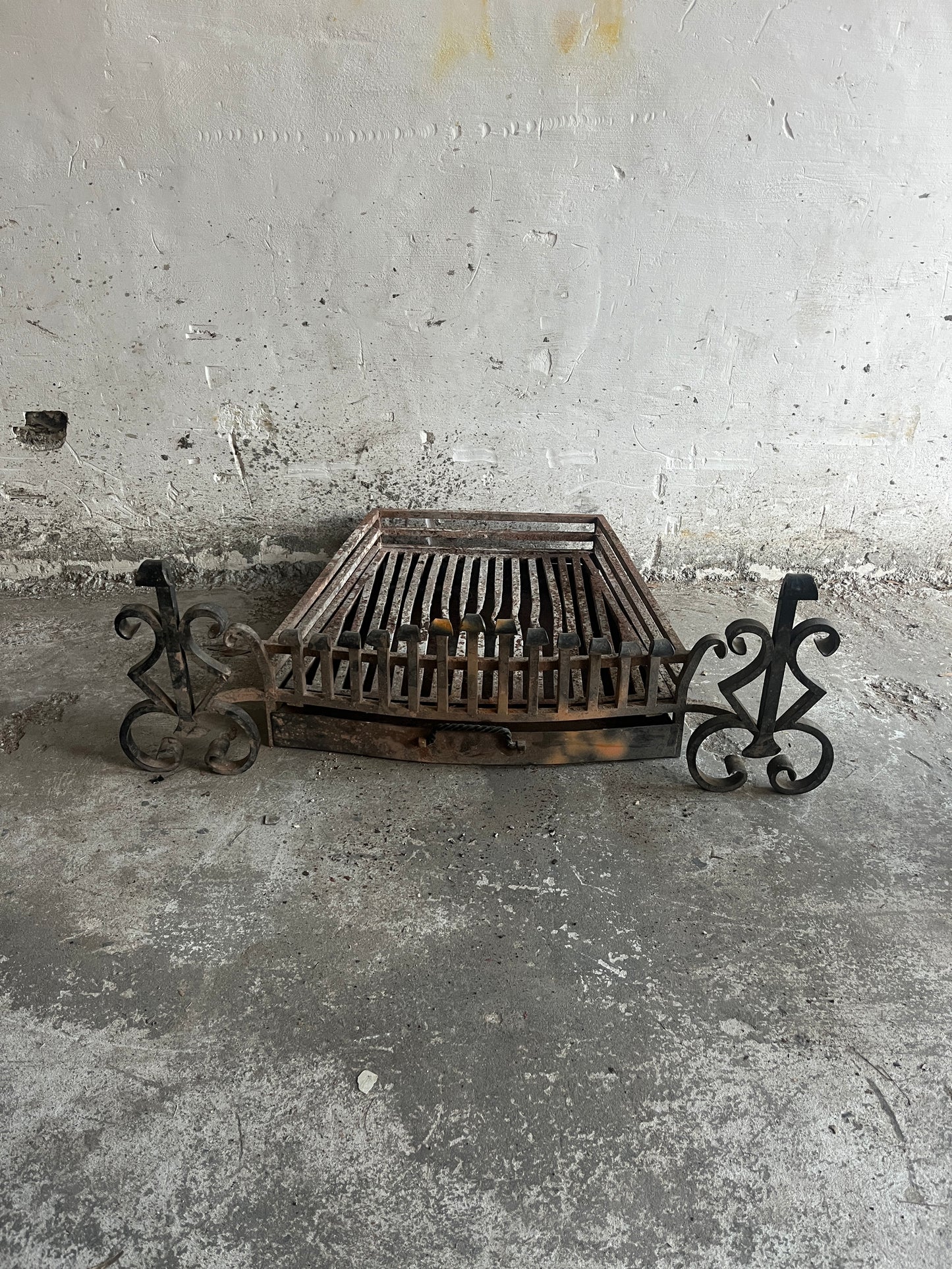 Vintage wrought iron fireplace grate with andirons
