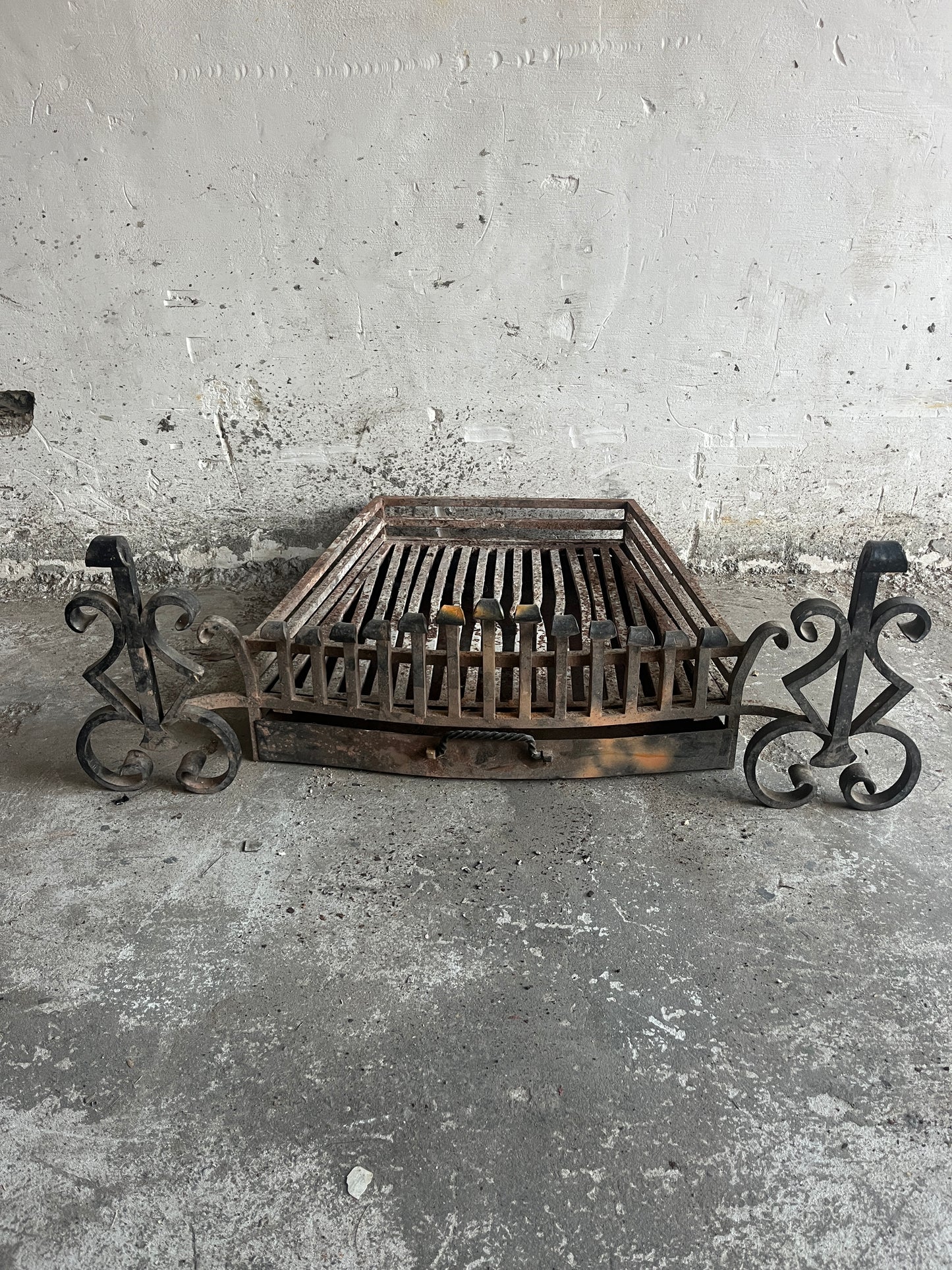 Vintage wrought iron fireplace grate with andirons