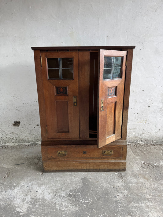 Arts & Crafts cabinet by DeCoene with stained glass panels