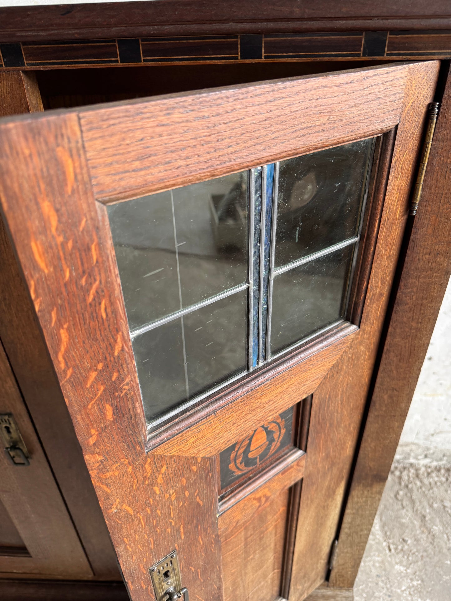 Arts & Crafts cabinet by DeCoene with stained glass panels