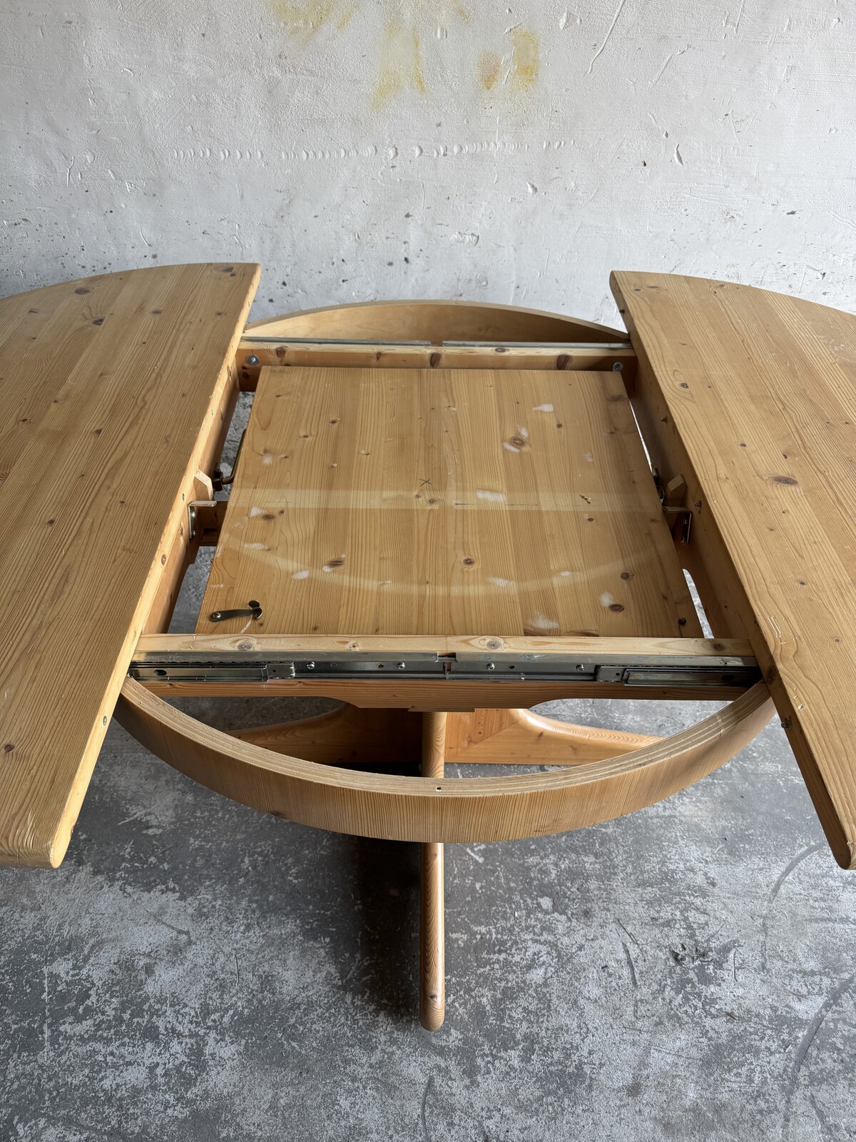 Extendable wooden dining table with integrated extension section