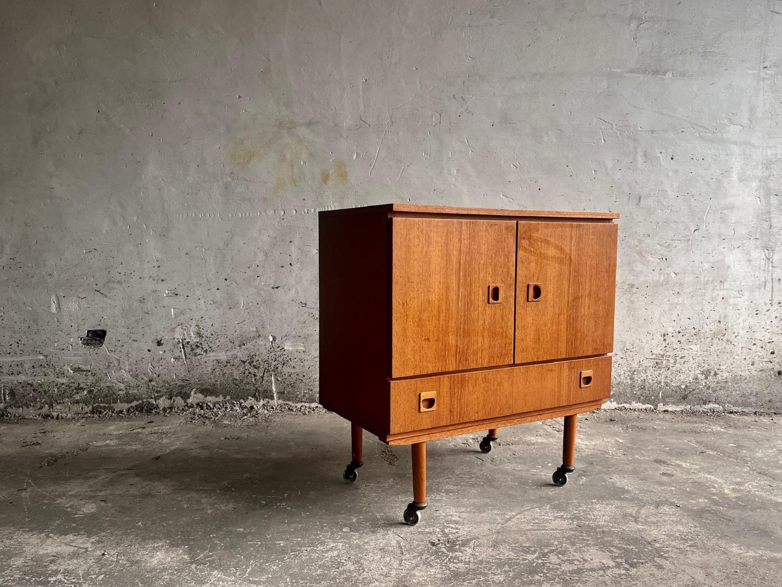 Vintage teakwood dressoir on wheels designed by Berner Huwel